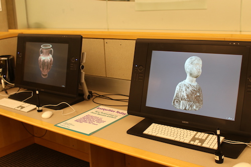 Two computers with 3D images of a vase on one screen and a statue on the other